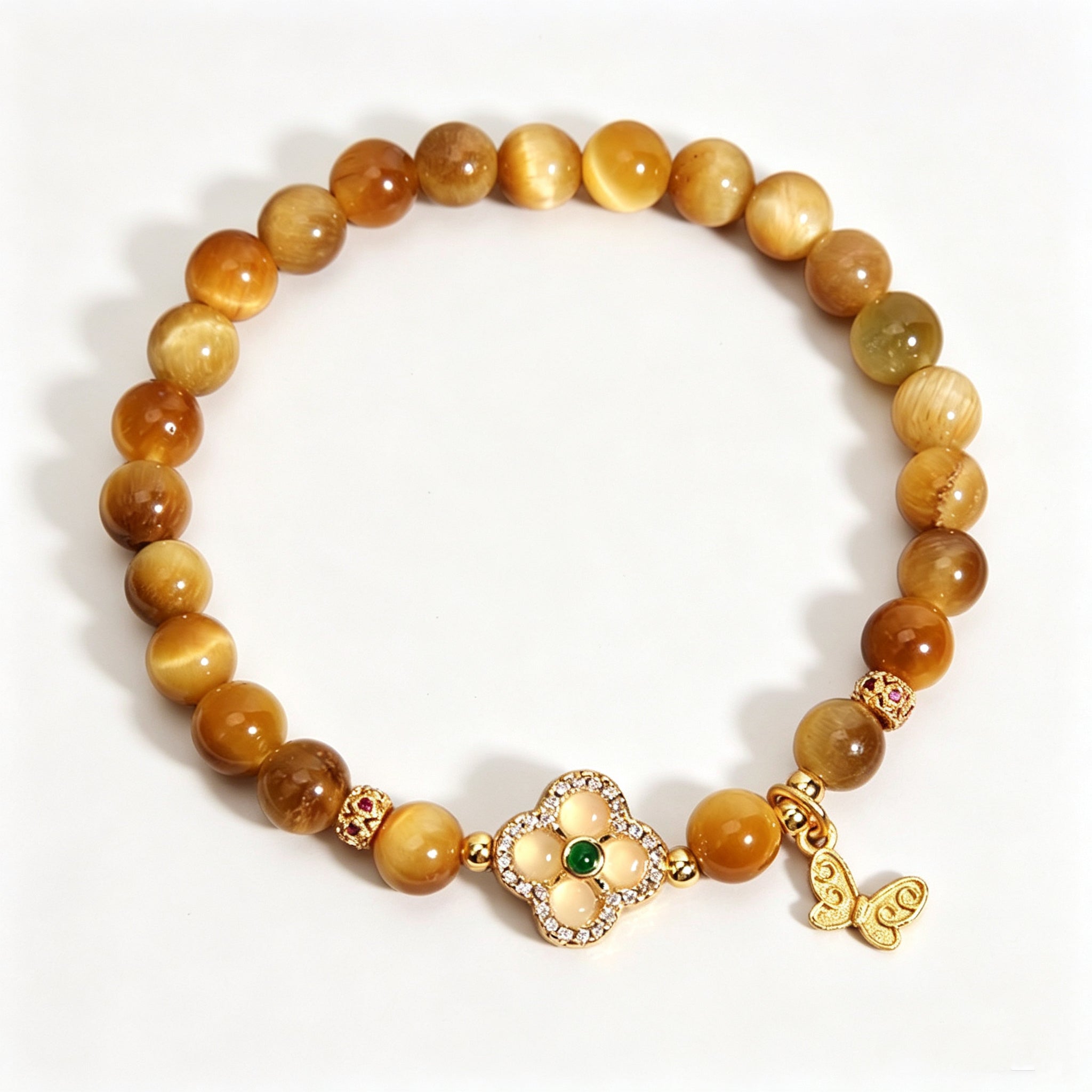 Earth Element golden tiger's eye bracelet, oriental five elements aesthetic women jewelry with four-leaf clover and butterfly pendant, plain white background e-commerce product shot