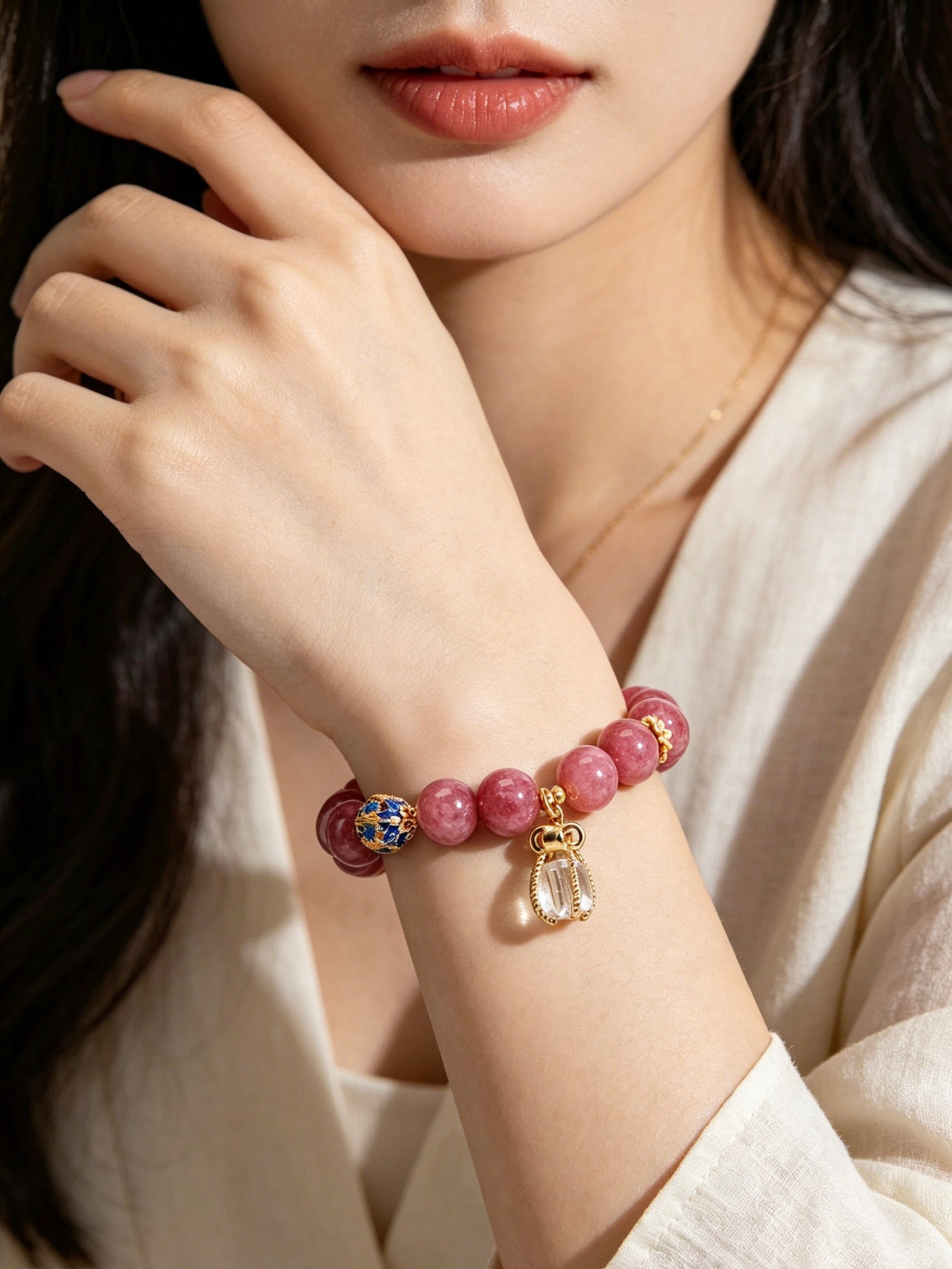 Vertical slow motion video showcasing oriental fire series pink tourmaline bracelet on female wrist, delicate handmade stone jewelry daily wearing effect, no face visible
