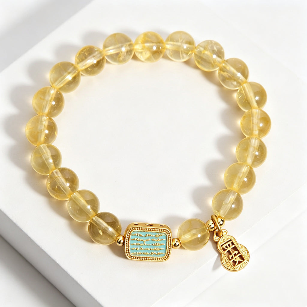 Top full flat lay shot of metal element yellow citrine bracelet, complete display of transparent golden crystal beads and gold hardware, minimalist white display platform