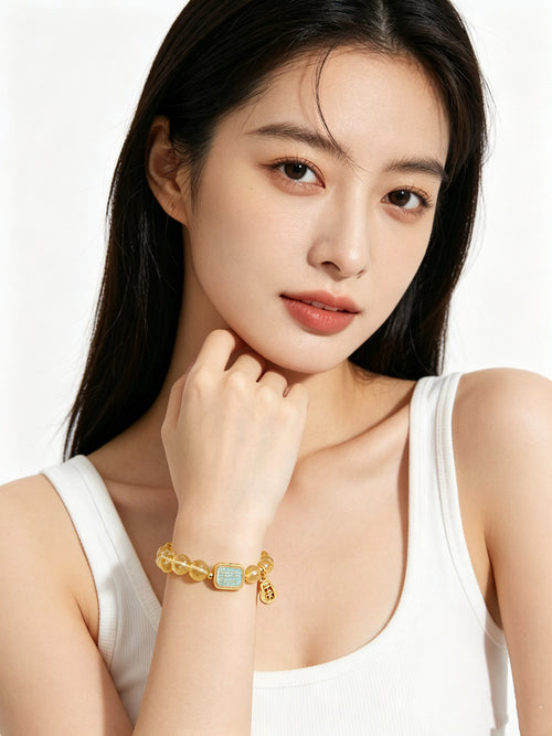 Partial upper body shot of woman in minimalist white vest showcasing warm golden tone citrine bracelet, clean all-white background, new oriental aesthetic daily accessory