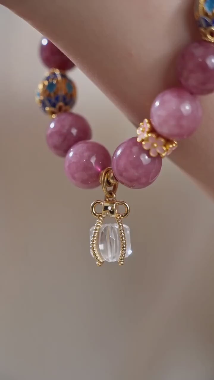 Vertical slow motion video showcasing oriental fire series pink tourmaline bracelet on female wrist, delicate handmade stone jewelry daily wearing effect, no face visible
