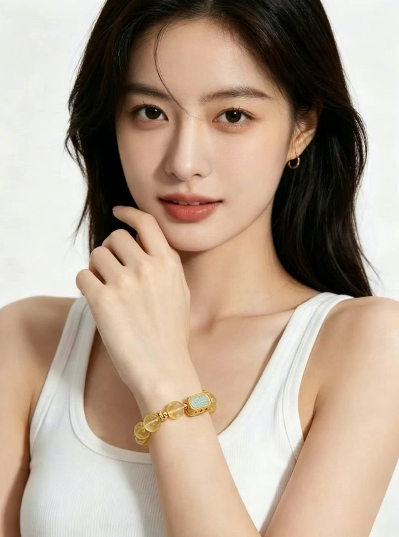Vertical 3:4 slow motion footage displaying Metal Balance citrine crystal bracelet worn on female wrist, model in plain white tank top, plain white background oriental crystal jewelry showcase, no extra accessories
