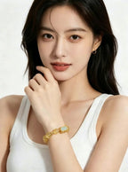 Vertical 3:4 slow motion footage displaying Metal Balance citrine crystal bracelet worn on female wrist, model in plain white tank top, plain white background oriental crystal jewelry showcase, no extra accessories