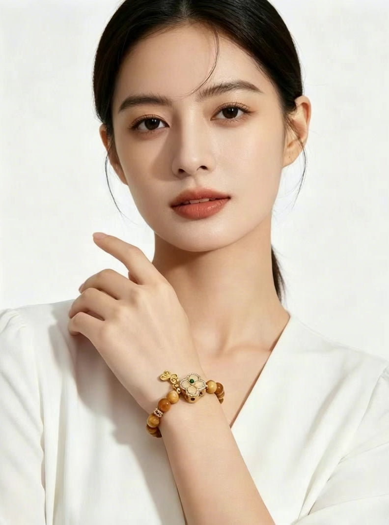 Vertical 3:4 slow motion footage showing Earth Element golden tiger's eye bracelet worn on female wrist, model in white clothes, plain white background oriental jewelry showcase