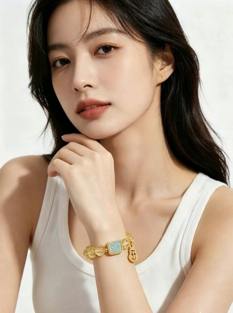 Slow close-up vertical short video of woman rotating wrist to show transparent golden luster of natural citrine beads, solid white background, only one bracelet on wrist