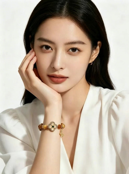 Slow close-up vertical video of woman rotating wrist to show cat-eye luster of Earthly Nurture tiger's eye bracelet, solid white background, no extra accessories