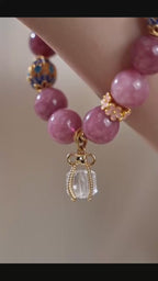 Close-up of a female wrist wearing a pink tourmaline & clear quartz beaded bracelet, Chinese style dainty jewelry display