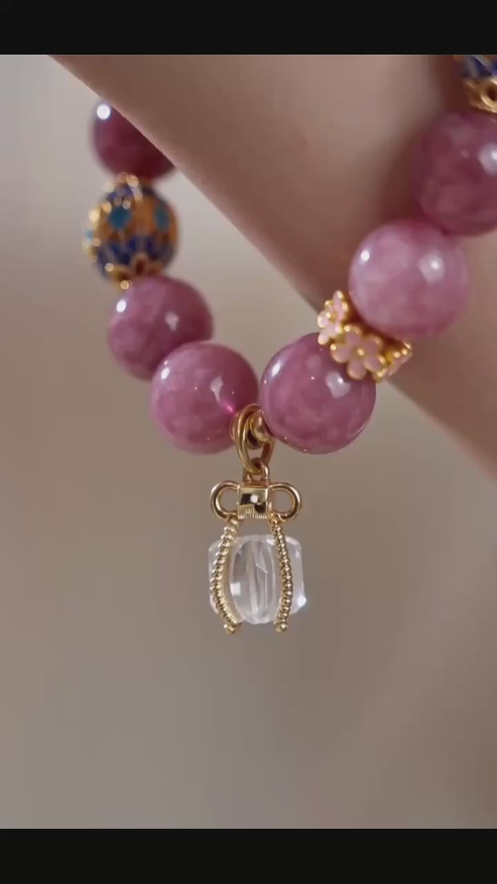 Close-up of a female wrist wearing a pink tourmaline & clear quartz beaded bracelet, Chinese style dainty jewelry display