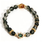 Wood Element Wooden Growth green phantom crystal bracelet, oriental five elements aesthetic women jewelry with emerald inlaid ornament and golden rutilated bead, plain solid white background e-commerce main product shot