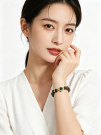 Partial upper body shot of lady in all-white minimalist clothing showcasing fresh green tone green phantom bracelet, clean blank white background, new oriental aesthetic accessory